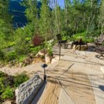 Vail-Mountain-Elegant-custom-stone-firepit-with-steelog-fire-flagstone-patio